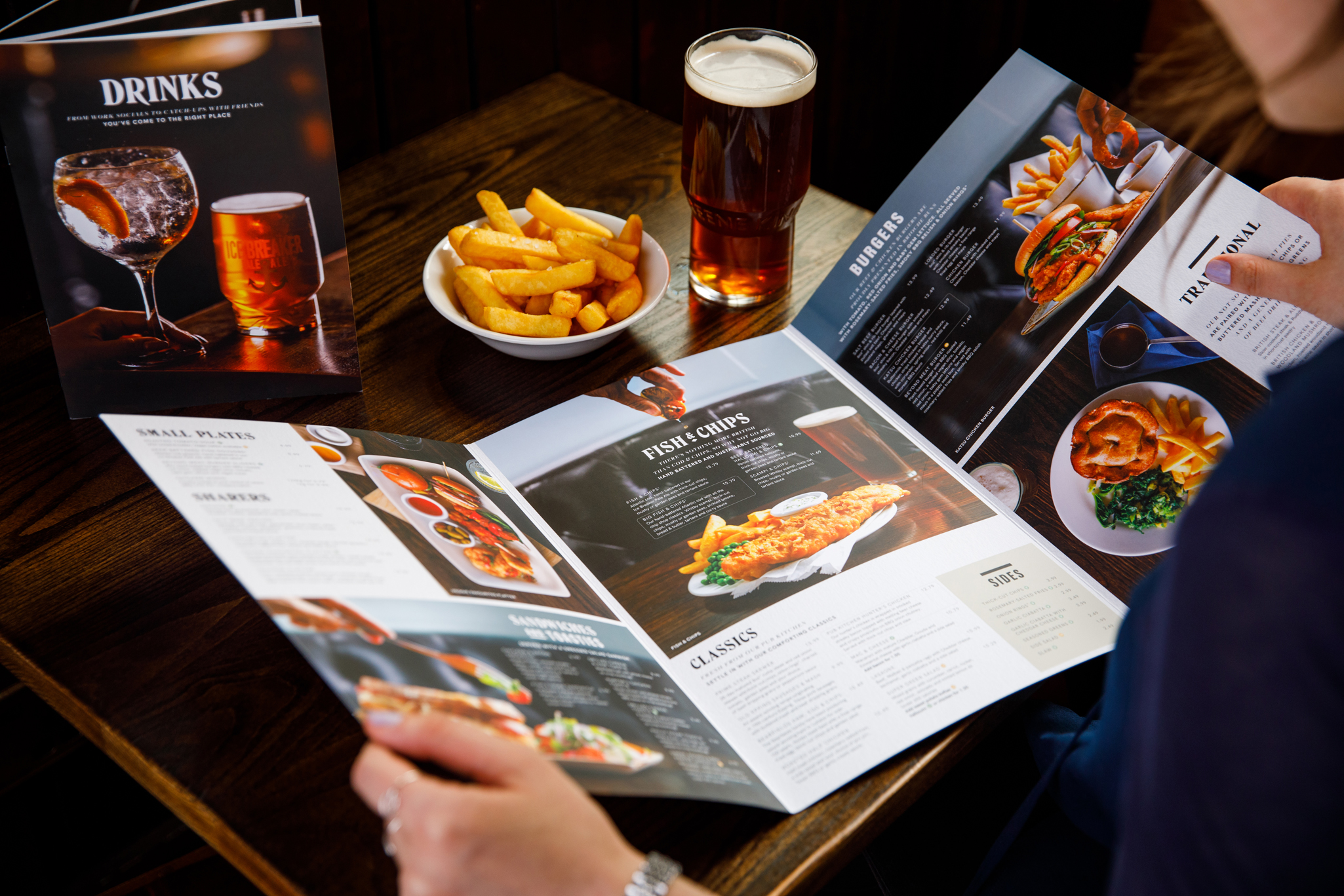 photo of a pub food menu being read by a woman
