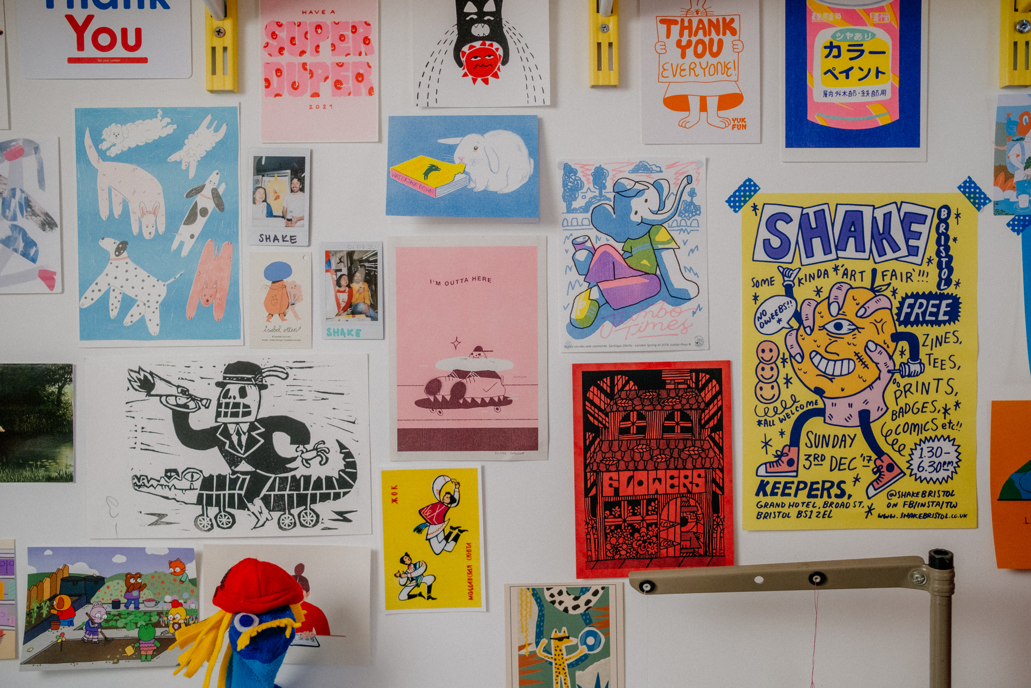 photograph of a wall of illustrations in various sizes and colours
